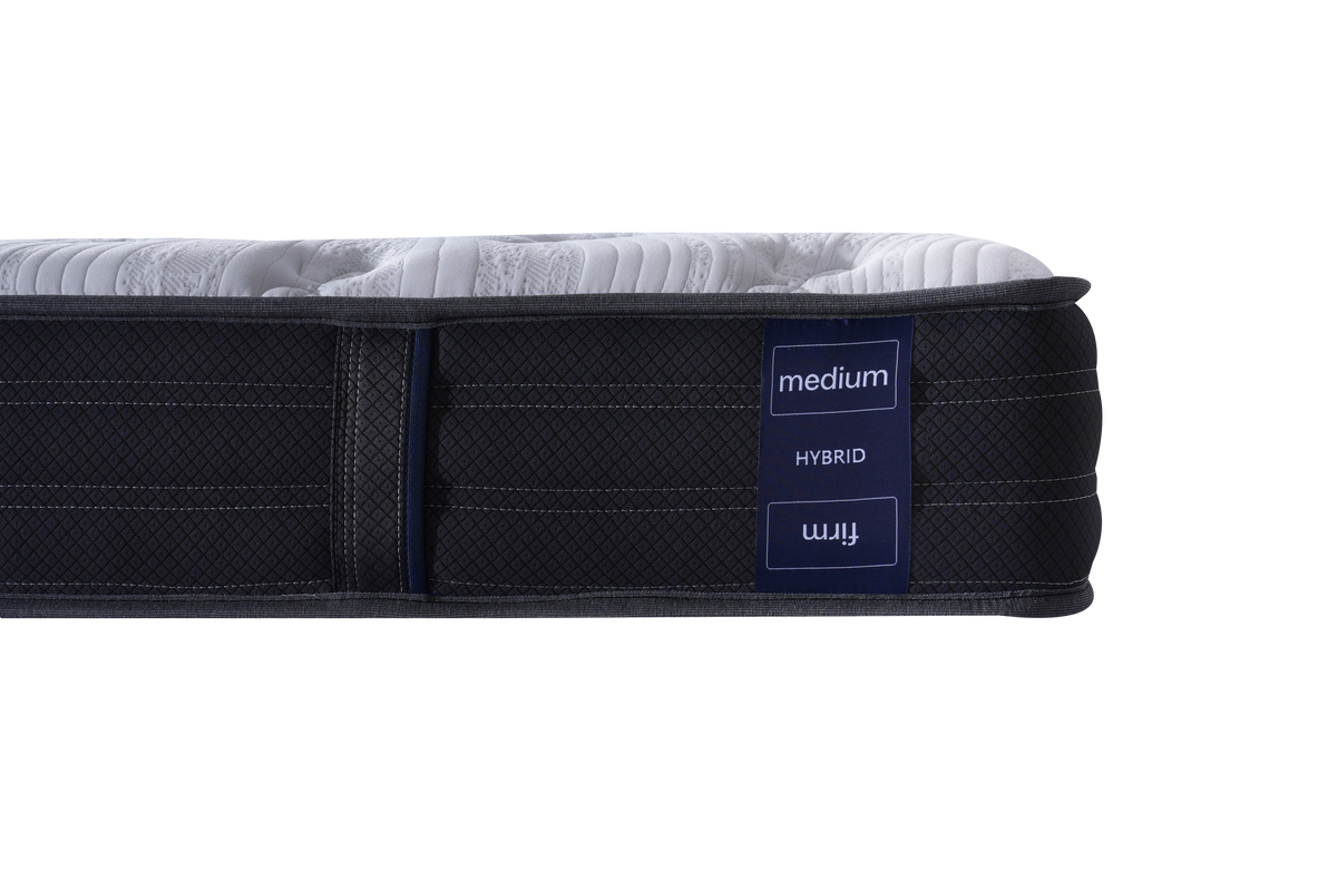 Side view of a medium hybrid mattress with a dark textured side panel, a white quilted top surface, and a navy blue label showing the brand 'mij' and the text 'medium HYBRID'.