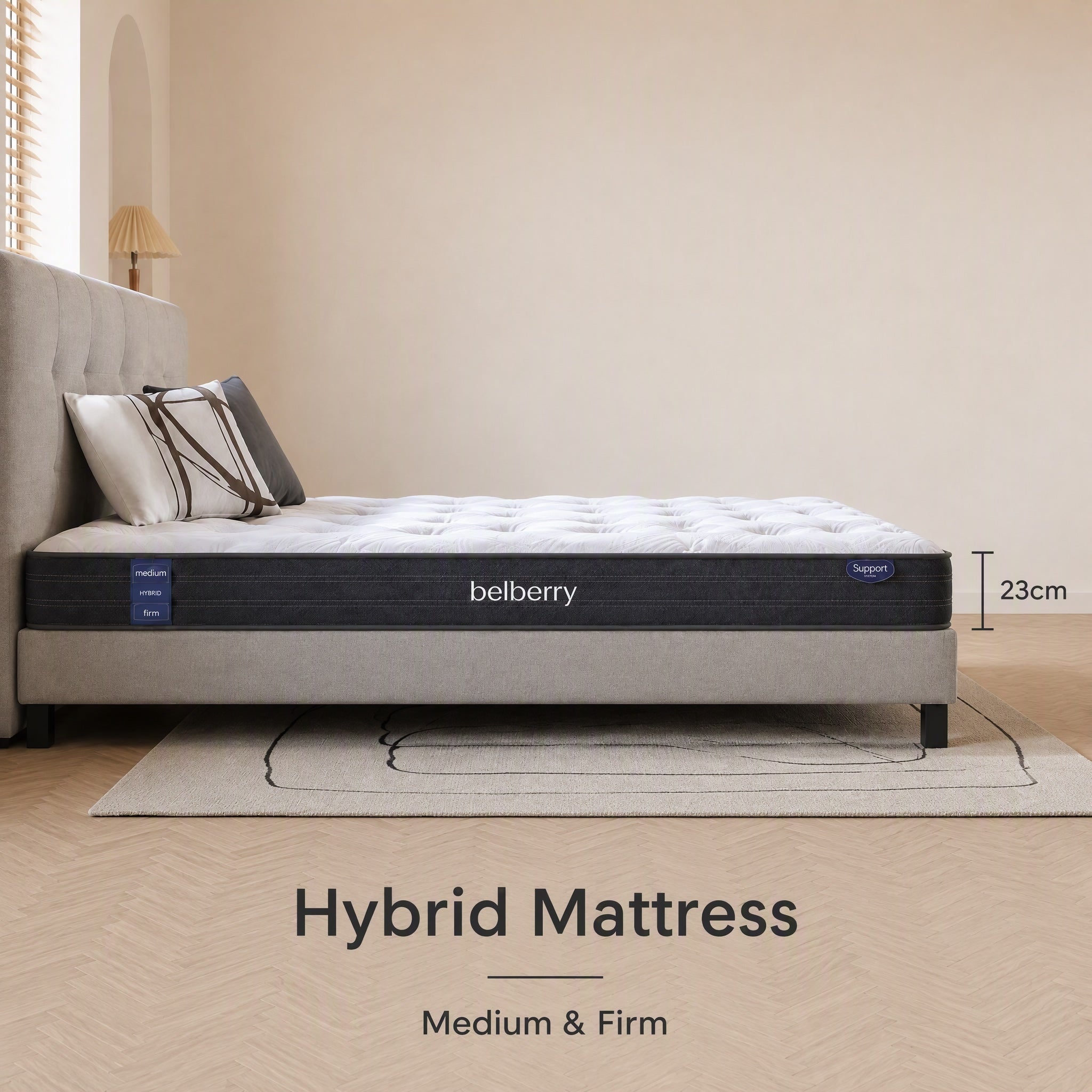 A bed with a belberry Hybrid Mattress in a modern bedroom setting. The mattress features a white tufted top and a dark gray side panel with blue brand accents.